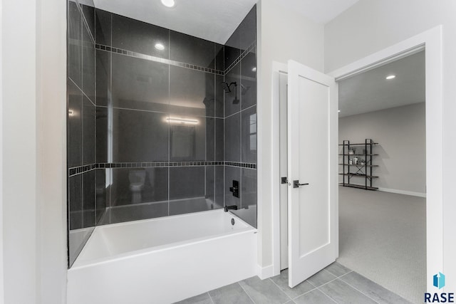 bathroom featuring tile patterned flooring and tiled shower / bath combo