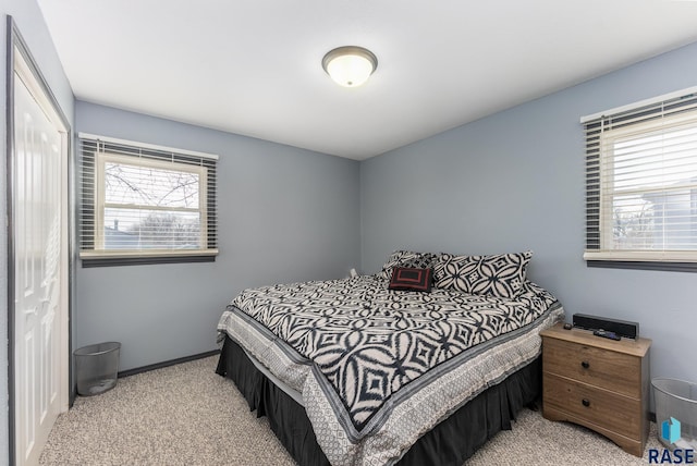 bedroom with light carpet and a closet