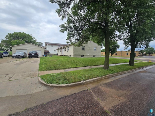 view of front of property with a garage, an outbuilding, and a front yard