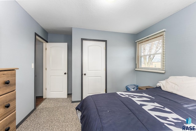 carpeted bedroom with a textured ceiling