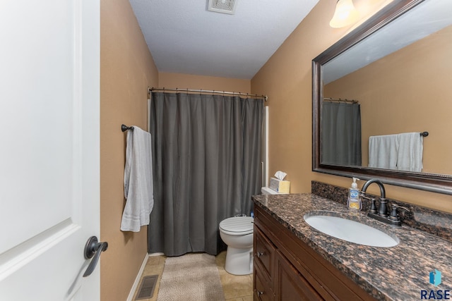 bathroom with tile patterned floors, vanity, and toilet