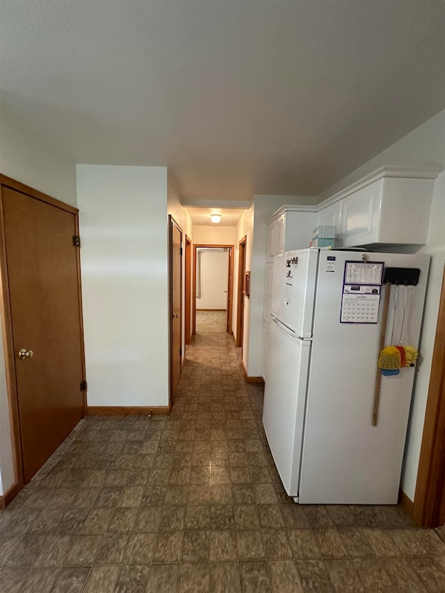 corridor featuring dark tile floors