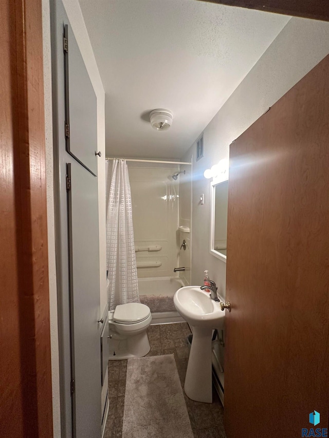 bathroom with shower / bathtub combination with curtain, tile flooring, and toilet