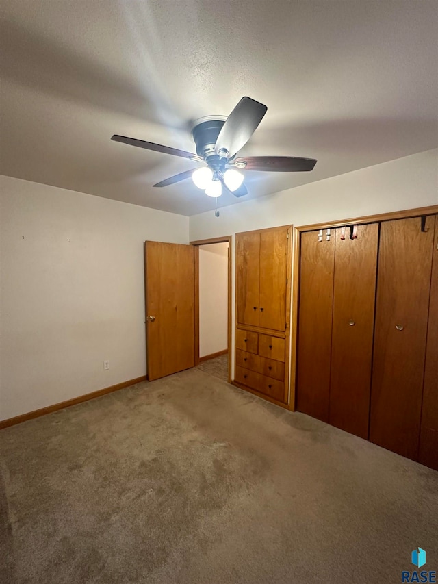 unfurnished bedroom with light carpet and ceiling fan