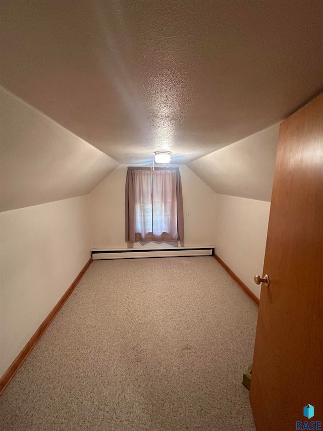 bonus room featuring a textured ceiling, carpet flooring, and lofted ceiling