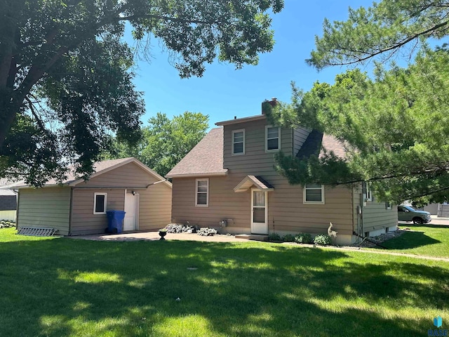 rear view of house featuring a yard