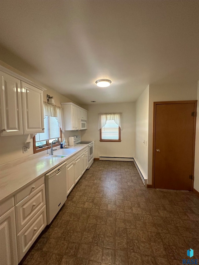 kitchen featuring white appliances, white cabinets, sink, and dark tile floors