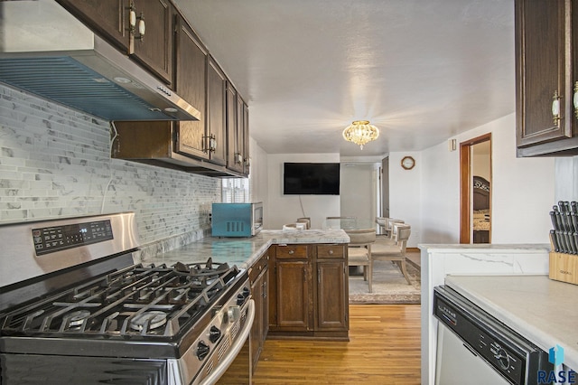 kitchen featuring decorative backsplash, dark brown cabinets, stainless steel appliances, and light hardwood / wood-style flooring