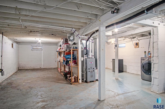 basement featuring washer / dryer and heating unit