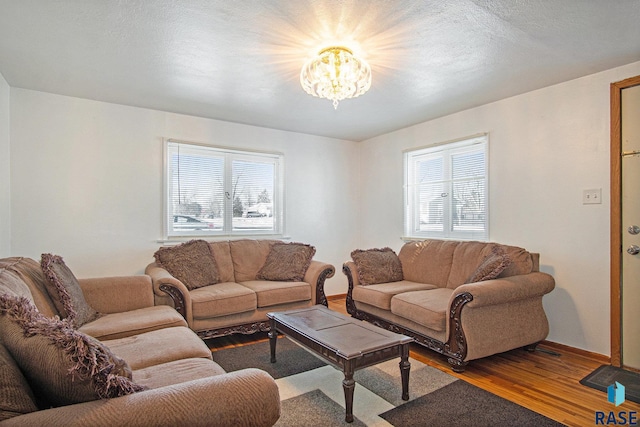 living room featuring hardwood / wood-style flooring and a chandelier