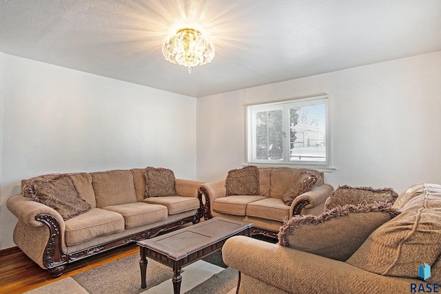 living room featuring hardwood / wood-style flooring and a notable chandelier