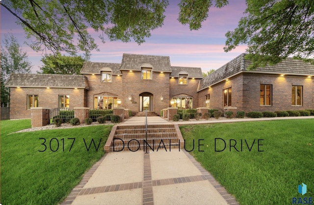 french provincial home featuring a lawn