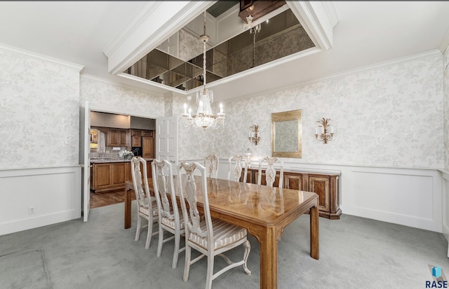 carpeted dining space featuring a notable chandelier and ornamental molding