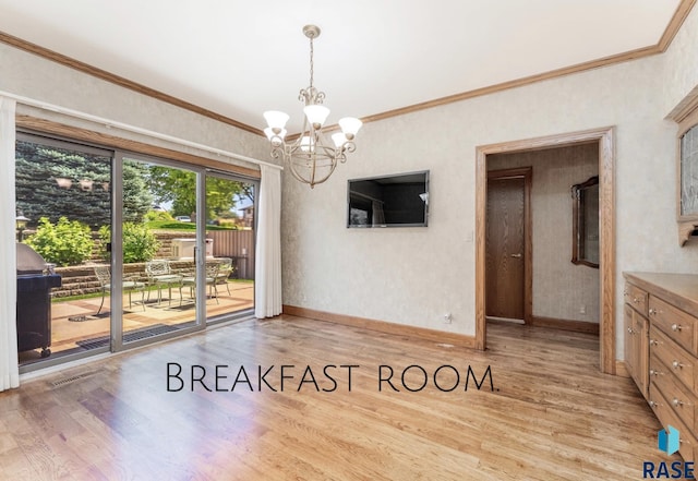 unfurnished dining area featuring an inviting chandelier, crown molding, and light hardwood / wood-style flooring