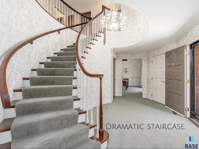 stairs featuring an inviting chandelier and carpet flooring