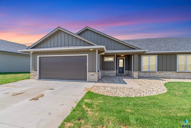 view of front of property featuring a garage and a yard