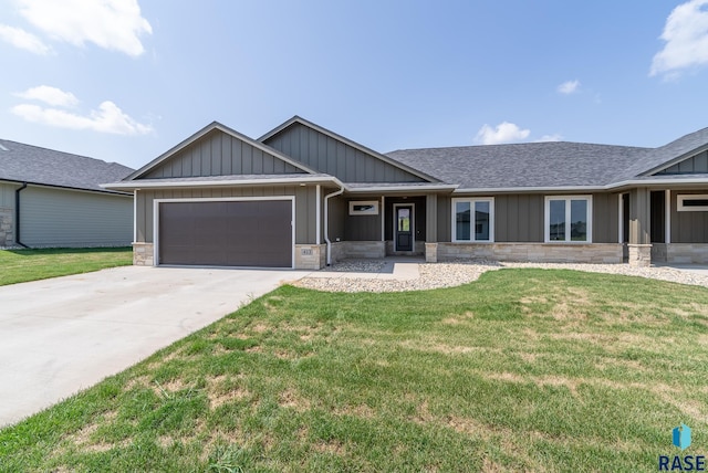 view of front of property with a garage and a front lawn