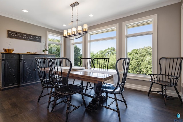dining area featuring dark hardwood / wood-style floors, an inviting chandelier, and crown molding