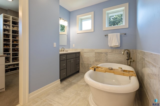 bathroom with vanity and a tub to relax in