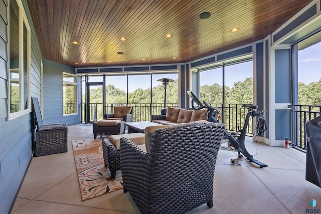sunroom / solarium featuring a wealth of natural light and wooden ceiling