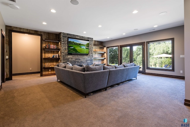 living room featuring built in shelves and light colored carpet