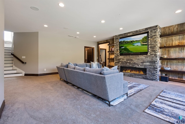 carpeted living room featuring a fireplace