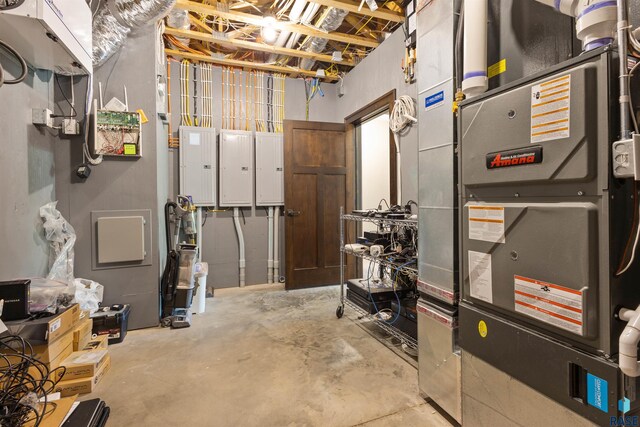 utility room with electric panel and heating unit