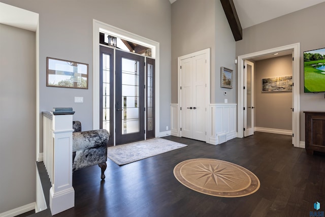 entrance foyer featuring vaulted ceiling with beams and dark hardwood / wood-style flooring