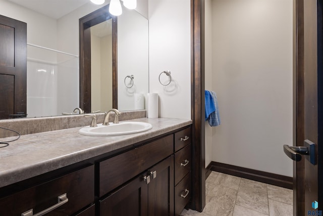 bathroom with a shower and vanity