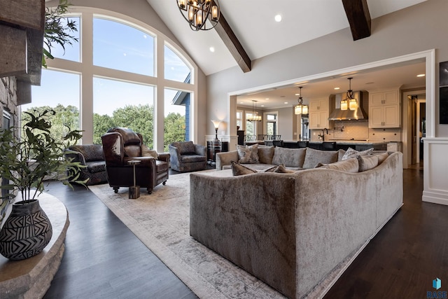 living room with beam ceiling, dark wood-type flooring, high vaulted ceiling, and a chandelier