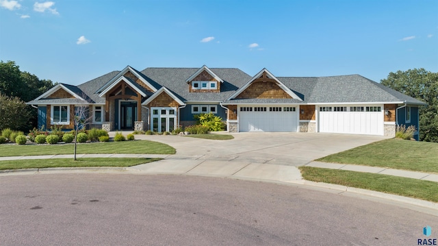 craftsman house with a front yard and a garage