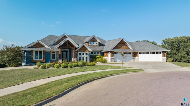 craftsman-style house featuring a garage and a front yard