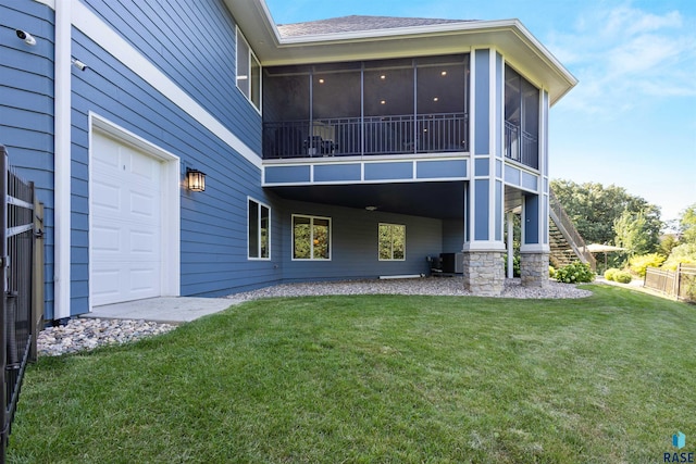 back of house with a sunroom, central AC, and a lawn