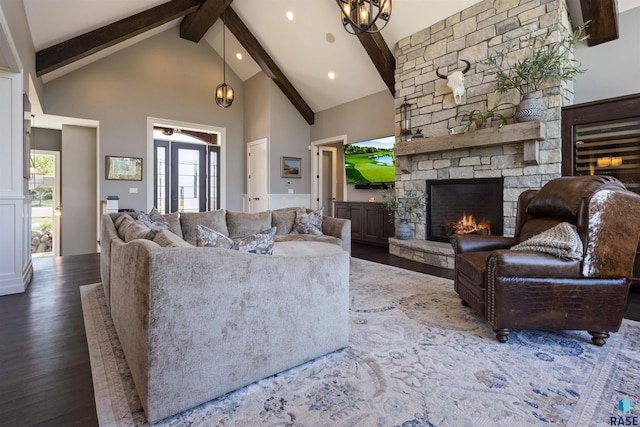 living room featuring an inviting chandelier, dark hardwood / wood-style flooring, beamed ceiling, high vaulted ceiling, and a fireplace