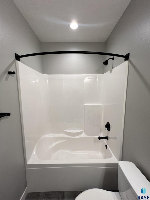 bathroom with shower / bathing tub combination and toilet