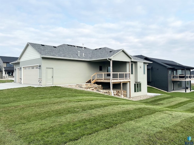 rear view of house with a garage and a lawn