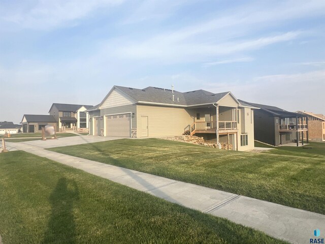 view of front of house with a garage and a front lawn