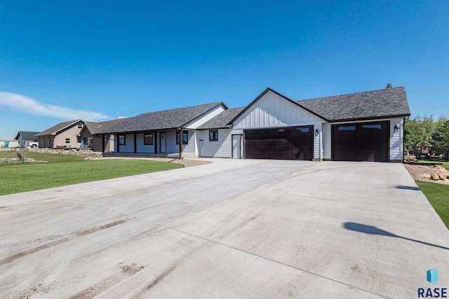 single story home featuring a garage and a front yard