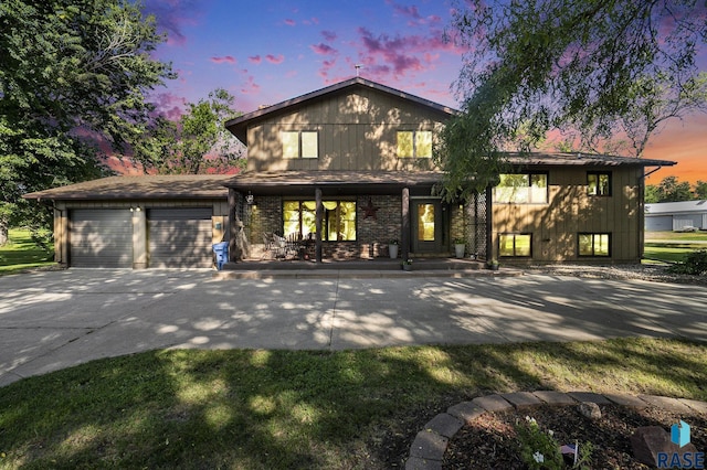 view of front of property with covered porch and a garage