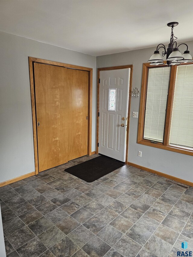 foyer with a chandelier