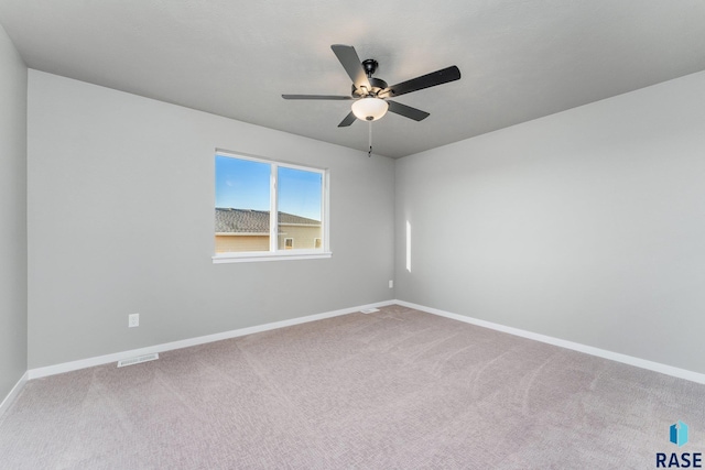 carpeted spare room featuring ceiling fan