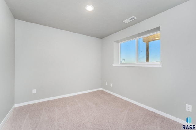 spare room with light colored carpet