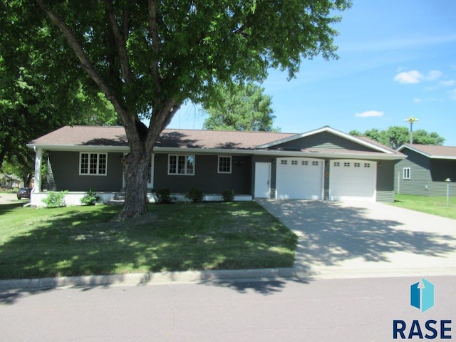 ranch-style home with a garage and a front yard