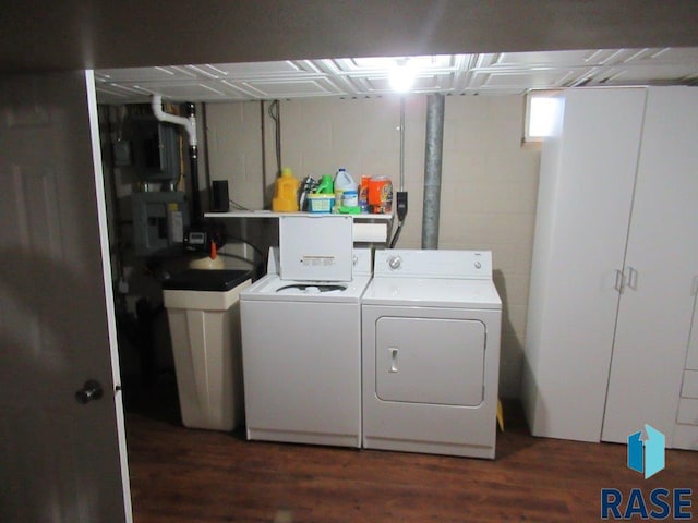 laundry room with laundry area, dark wood finished floors, and washer and clothes dryer