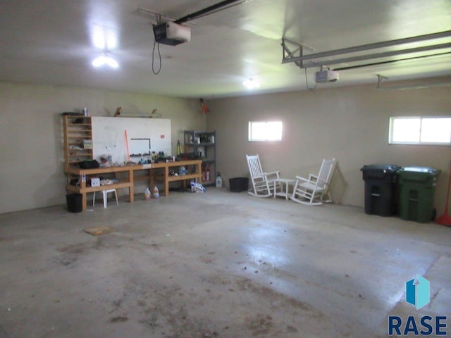 garage with a workshop area and a garage door opener