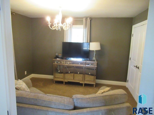 living room with carpet floors, baseboards, and a notable chandelier