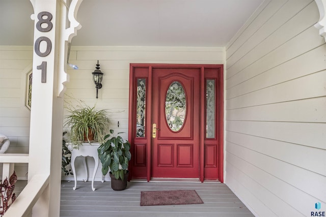 view of exterior entry featuring a porch