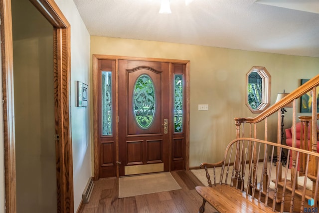 entrance foyer with a textured ceiling and hardwood / wood-style floors