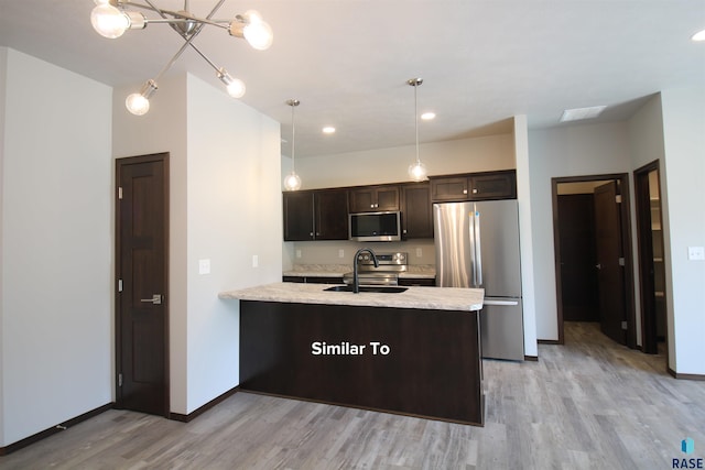 kitchen featuring light hardwood / wood-style flooring, stainless steel appliances, decorative light fixtures, dark brown cabinetry, and sink