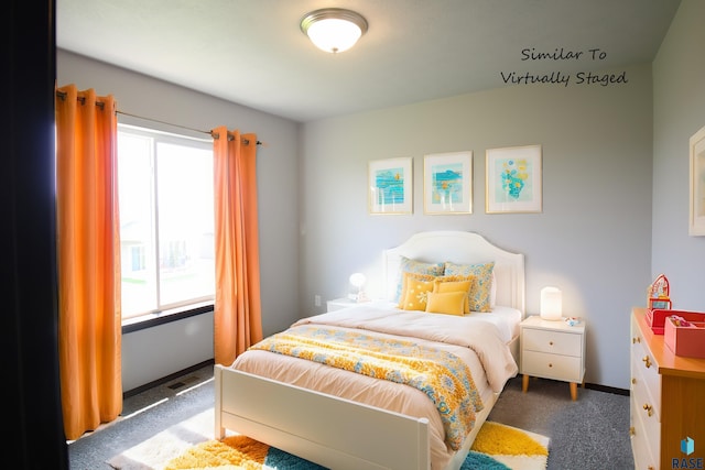 bedroom with multiple windows and dark colored carpet